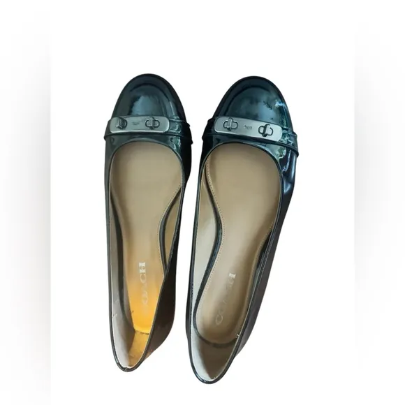 COACH Oswald Black Patent Leather Ballerina Flats with Metal Buckle Accent.
