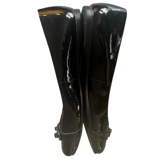 COACH Oswald Black Patent Leather Ballerina Flats with Metal Buckle Accent.