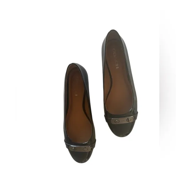 COACH Oswald Black Patent Leather Ballerina Flats with Metal Buckle Accent.