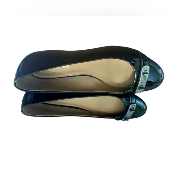 COACH Oswald Black Patent Leather Ballerina Flats with Metal Buckle Accent.