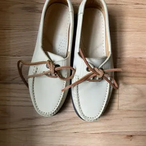 Cream and Brown Moccasins with Visible Stitching and Slip-On Design