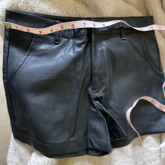Design by Korea, approx 28” NWOT black synthetic leather short w/ front pockets.