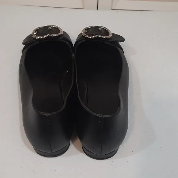 Gucci Black Leather Flats with Silver Buckle.