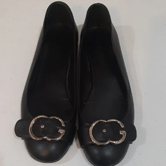 Gucci Black Leather Flats with Silver Buckle.