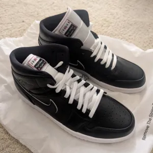 Nike Black and White Mid-Top Sneakers with Padded Collar Air Jordan 1