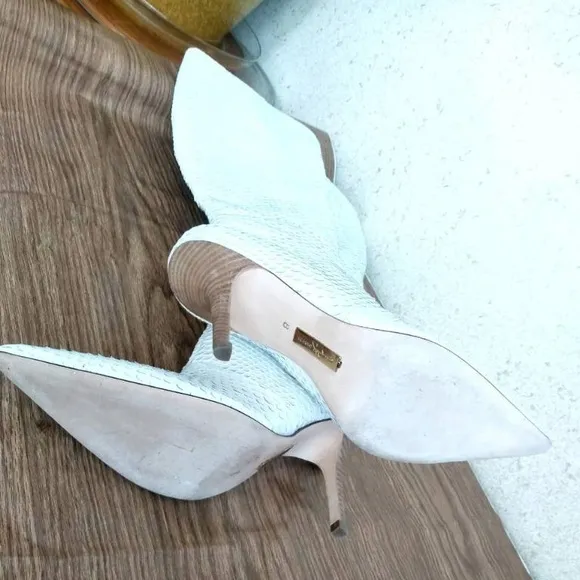 Report Signature white leather heeled boots in size 8. Made in Brazil.