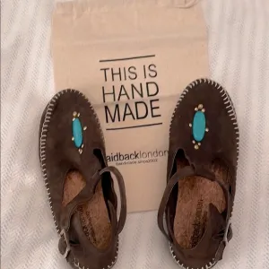 Sundance   Laidback London suede, whipstiched, moccasins w/ turquoise accents.
