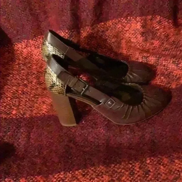 Women’s brown leather heels with snakeskin.