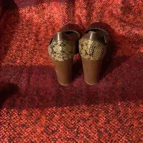 Women’s brown leather heels with snakeskin.